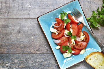 Tomato salad with feta,onion and parsley.Top view.