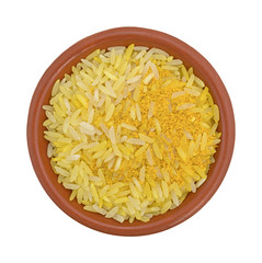 Saffron yellow rice in a bowl top view isolated on a white background.