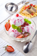 Ice Cream with Strawberry, Mint and waffles. Homemade product. On the wooden table.