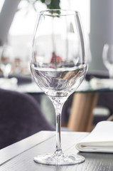 Wine glass on a wooden table in a restaurant