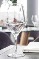 Wine glass on a wooden table in a restaurant