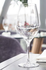 Wine glass on a wooden table in a restaurant