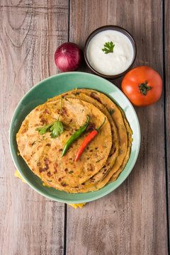 Traditional Indian bread - Aloo paratha or aalu parotha, potato stuffed bread. served with tomato ketchup or sauce and curd