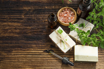 Obraz na płótnie Canvas Herbal spa treatment with oil, natural soap, sea salt and green