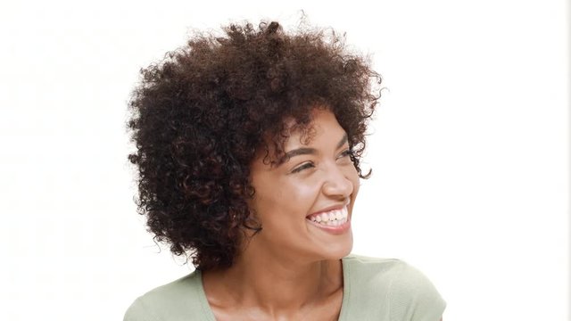 Young beautiful african girl laughing over white background.