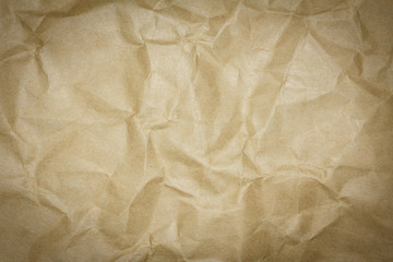 Closeup brown recycled crumpled paper texture. Brown recycled crumpled paper background with copy space for text or image. Dark edged.