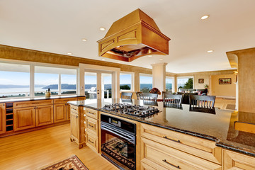 Luxury kitchen with water view, island and sink.