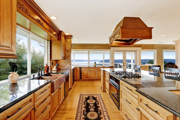 Luxury kitchen with water view, island and sink.