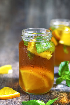 Orange iced tea in a glass jar.