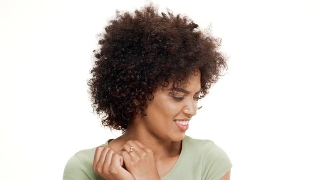 Annoyed young beautiful african girl over white background. Slow motion.