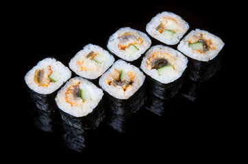 Japanese rolls on black background