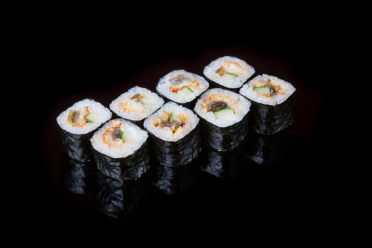 Japanese rolls on black background