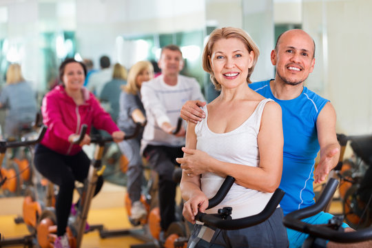 Sportive couple in a fitness club with friends