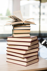 Stack of books arranged the office desk