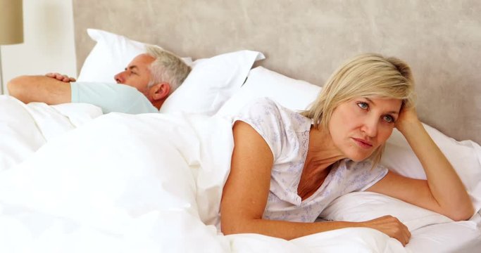 Couple not speaking to each other in bed