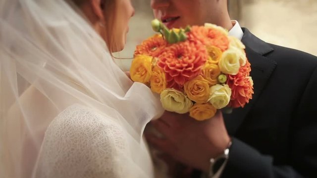 Wedding couple softly kissing close up