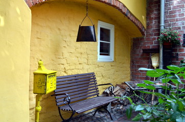 Fototapeta na wymiar small garden with bench in summertime