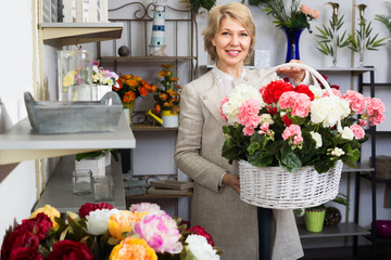 Mature female customer choosing flowers