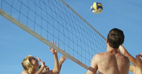 Friends playing beach volleyball