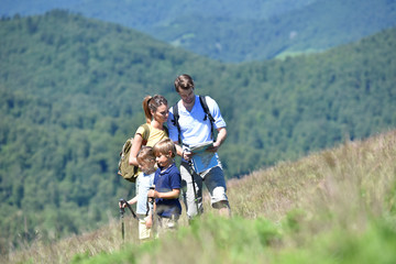 Family on a hiking day looking at map