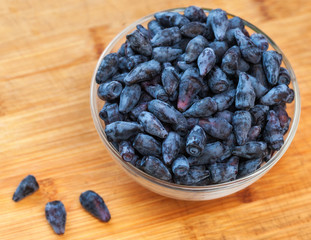Lot of fresh ripe honeysuckle berries on a plate