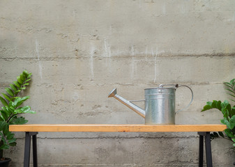 tin watering can on wooden bench © aon168