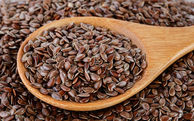 Flax seeds heap in wood spoon