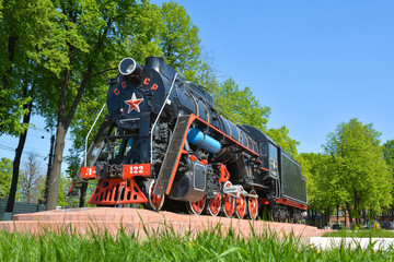 Old Soviet steam locomotive on the background of nature. Horizontal