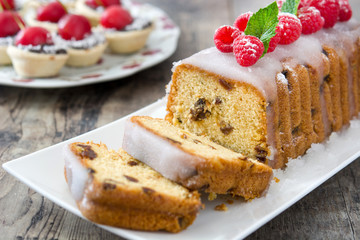 Christmas fruit cake and Christmas decoration on a rustic wooden table

