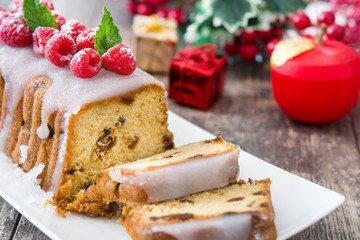 Christmas fruit cake and Christmas decoration on a rustic wooden table


