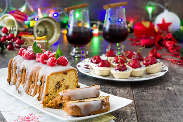 Christmas fruit cake and Christmas decoration on a rustic wooden table

