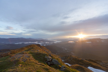 A beautiful sunrise in the clouds in the high mountains.