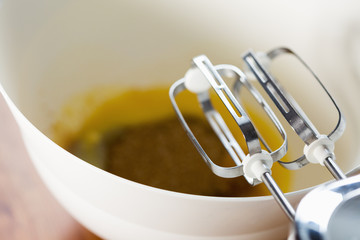 Whisking dough with mixer in a bowl