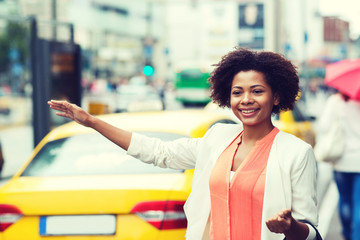 happy african woman catching taxi