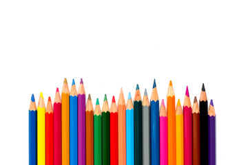 Row of color pencil placed on white background
