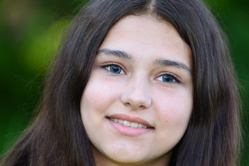 Portrait of teen brunette with blue lenses in eyes