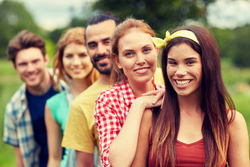 group of smiling friends outdoors