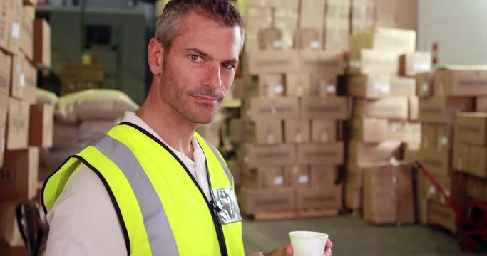 Warehouse worker sending a text on his break