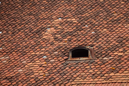 Color picture of red tile roof with skylight