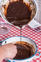 Pouring chocolate cream in raw eggs cream