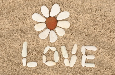 flower stone, lying on the sand. made of white pebbles and red. for designers and print