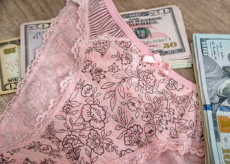 Woman's panties and one hundred dollars on desk