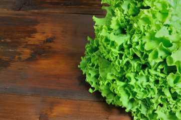 Fresh green salad on wooden background