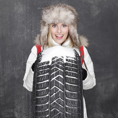 Woman with winter tyre 