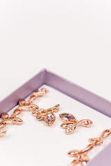 Macro image of golden earrings with diamond stones
