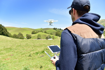 Man handling drone in nature