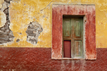 Mexico, San Miguel de Allende. Window in colorful wall.