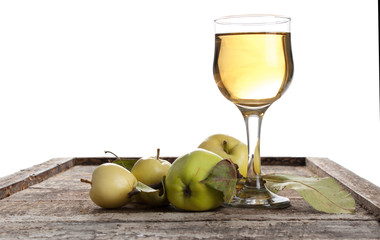 Glass of apple juice with green apples on wooden table, closeup
