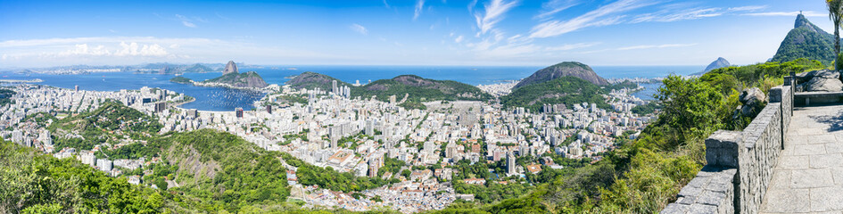 Fototapeta na wymiar Scenic panorama of the Rio de Janeiro, Brazil city skyline with Sugarloaf Mountain Botafogo and Guanabara Bay under bright blue Brazilian skies
