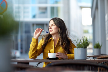 happy woman with notebook drinking cocoa at cafe